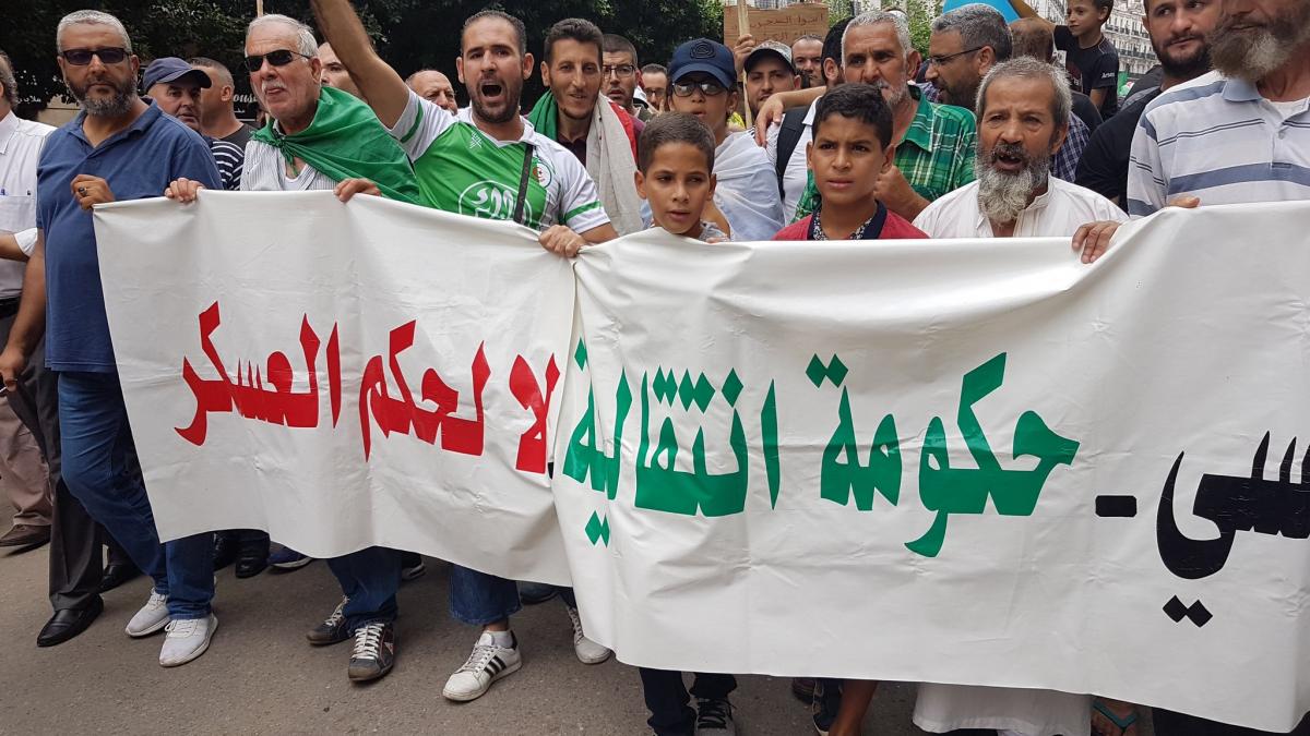 A banner from Friday's protests says "Transitional government ... No to military rule". Photo via <a  data-cke-saved-href="https://twitter.com/addadhakimnidha/status/1172522319174098945/photo/2" href="https://twitter.com/addadhakimnidha/status/1172522319174098945/photo/2">@addadhakimnidha</a.