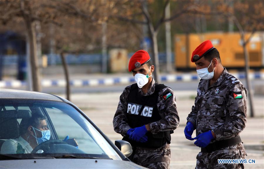 Police checking a vehicle during the lockdown in Jordan. Photo: Xinhua