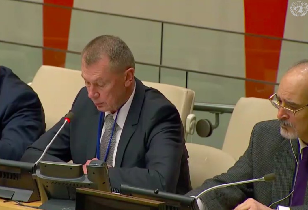 Russian representative Alexander Shulgin speaking at the UN on Monday, flanked by Syrian representative Bashar Jaafari (right)
